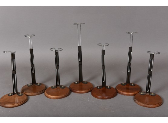 Collection Of Seven Adjustable Height Doll Stands