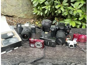 An Assortment Of Cameras And Camera Equipment - Pentax, Cannon, Nikon And More