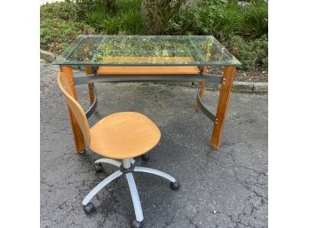 A Modern Desk And Chair With Glass Top