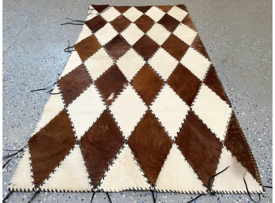 A Vintage Cow Skin Pillow And Throw Rug