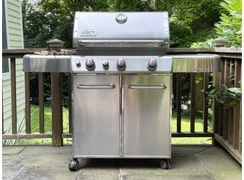 A Weber Genesis Natural Gas Grill With Side Burner, Cover, And Grill Tools