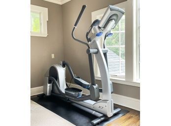 A Life Fitness X-7 Elliptical And Workout Pad