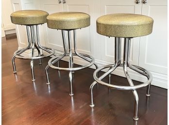 A Trio Of Vintage Chrome Diner Stools In Faux Snakeskin