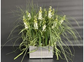 A Faux Green & White Floral Arrangement In A Square Metal Tin