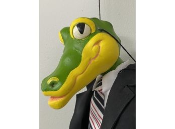 A Fun, Whimsical Alligator Marionette In A Suit & Tie