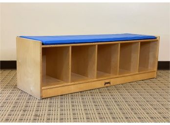 A Cubby Bench With A Blue Seat Cushion