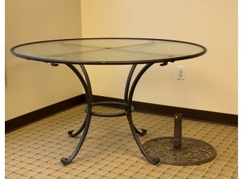 A Glass-Topped Outdoor Table & A Cast-Metal Umbrella Base