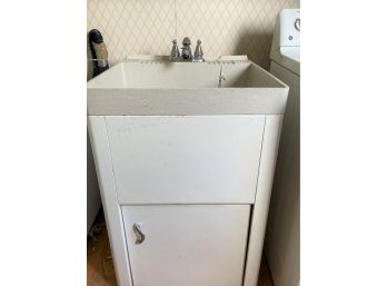 A Plastic Utility Sink With Metal Surround Storage Cabinet