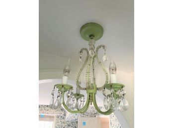 A Green Metal Chandelier With Beads And Crystals