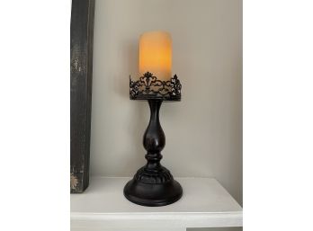 An Intricate Black Metal Candle Holder With Faux Candle