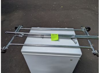 A Folding  Metal Clothing Rack With Wheels