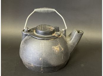 An Antique Cast Iron Kettle