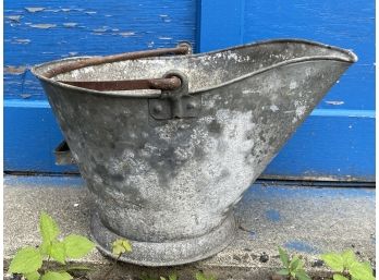 A Vintage Metal Bucket With Cast Handle