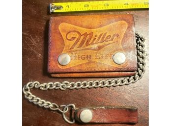 Vintaged Miller Light Embossed Leather Wallet On A Chair