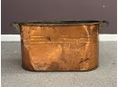 A Vintage Copper Tub With Wood Side Handles