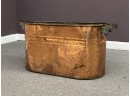A Vintage Copper Tub With Wood Side Handles
