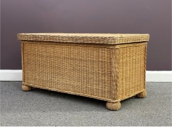 A Natural Wicker Chest With A Hinged Lid & Bun Feet