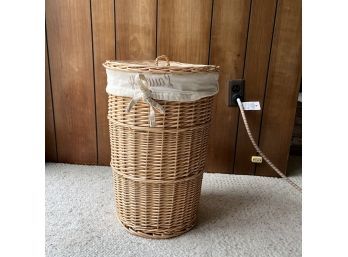 A Lined Wicker Laundry Hamper With Lid