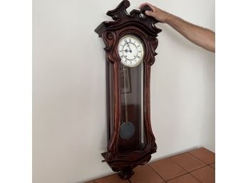 A Carved Mahogany Art Deco Pendulum Clock