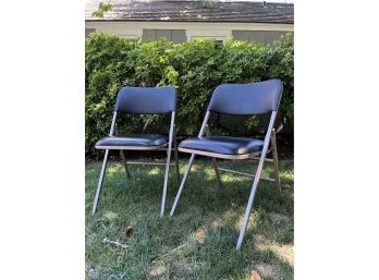 A Pair Of Metal And Pleather Folding Chairs