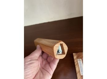 A Handcrafted Wooden Kaleidoscope With A Base For Display