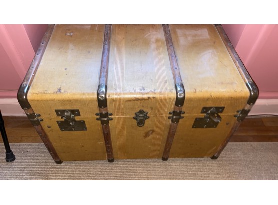 A Vintage Travel Trunk With Brass Accents & Plaid Lining