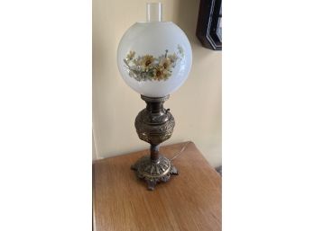A Vintage Oil Lamp With Hand Decorated Milk Glass Shade
