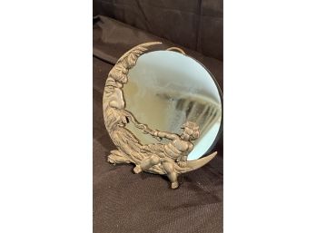 An Art Deco  Round Putti Vanity Mirror.