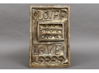 Wall Plaque That Spells Out Love Several Times
