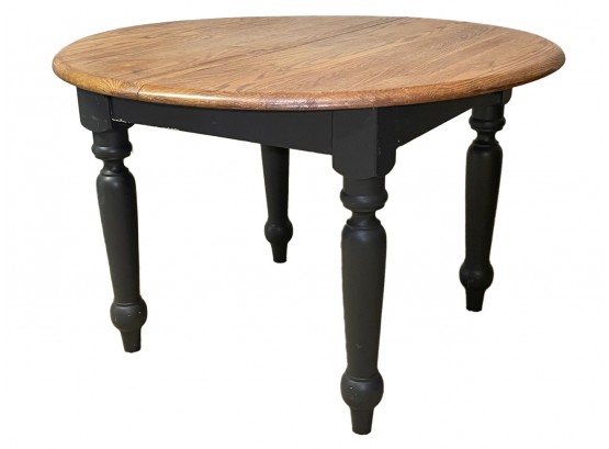 An Extendable Oak Dining Table With Painted Wood Base