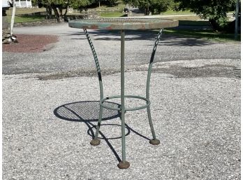 A Vintage Wrought Iron Side Table With Mesh Top