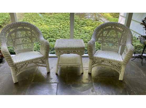 A Set Of White Wicker Chair With Table.