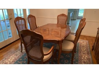 A Parquetry Solid Wood Dining Table With Two Leaves And Six Chairs. By Stanley Furniture