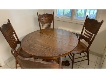 A Vintage Oak Single Pedestal Claw Foot Table With Four Pressed Back Chairs.
