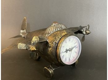 A Brass Toned Tin Plane Clock