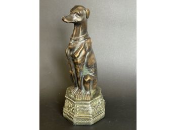 A Bronze Toned Dog Statue On Platform
