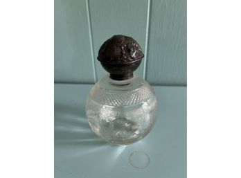 An Antique Perfume Bottle With Silver Top