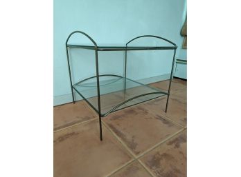A Metal And Glass End Table With Shelf
