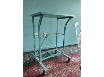 A Folding Metal Work Table On Wheels - In Aqua Made By Origami