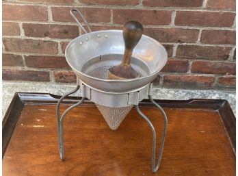 A Vintage Aluminum Cone Food Mill With Wooden Pestle