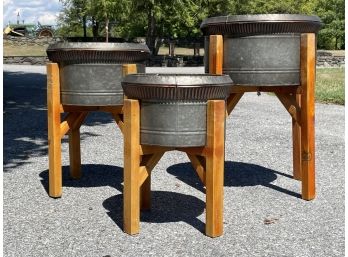 A Trio Of Galvanized Steel Cache Pots On Reclaimed Wood Stands