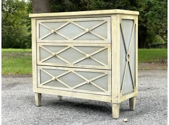 A Painted Wood Chest Of Drawers With Paneled Latticework Details