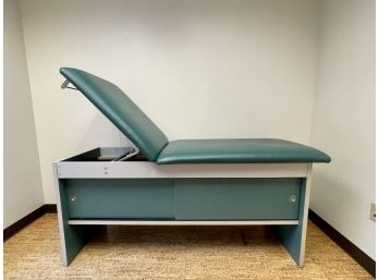 A Cabinet-Style Treatment Table With Adjustable Back #1