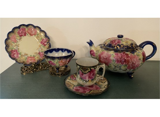 Teapot, Cups, And Saucers