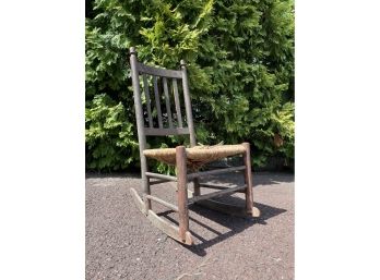 A Slat Back Antique Rocker With Original Paint And Rush Seat