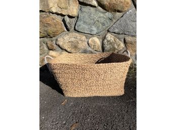 A Seagrass Basket With Leather Handles