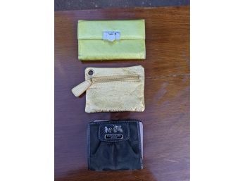 An Assortment Of Wallets Including Coach