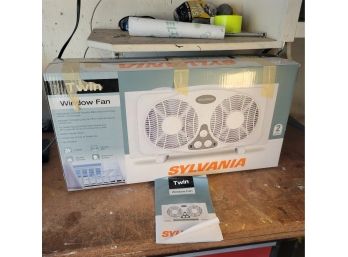 Sylvania Twin Window Fan In Box.         (Loc Garage Floor)