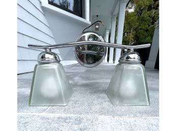 A Double Light Bathroom Light Fixture In Chrome With Frosted Glass Shades