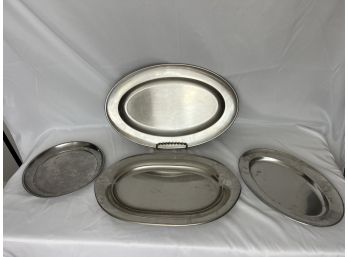 Four Stainless Steel Serving Platters